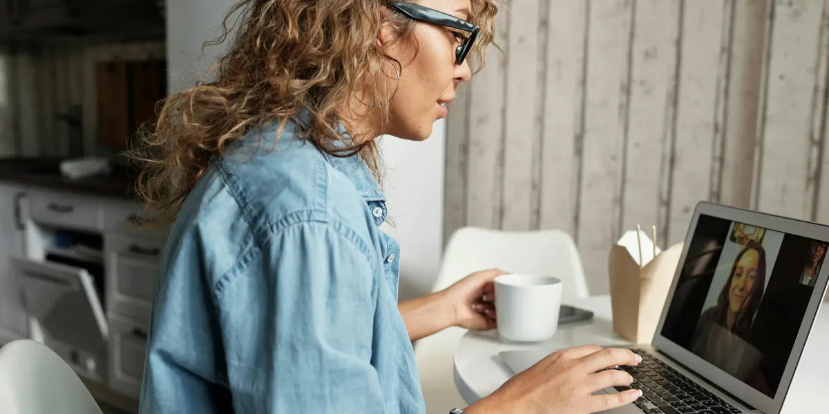 Parent using a laptop in a home office setting